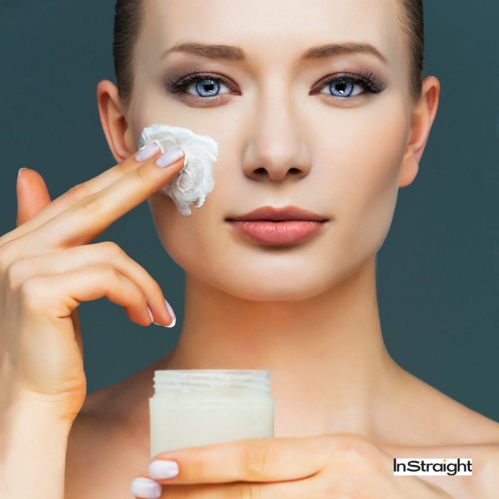 woman moisturizing her face